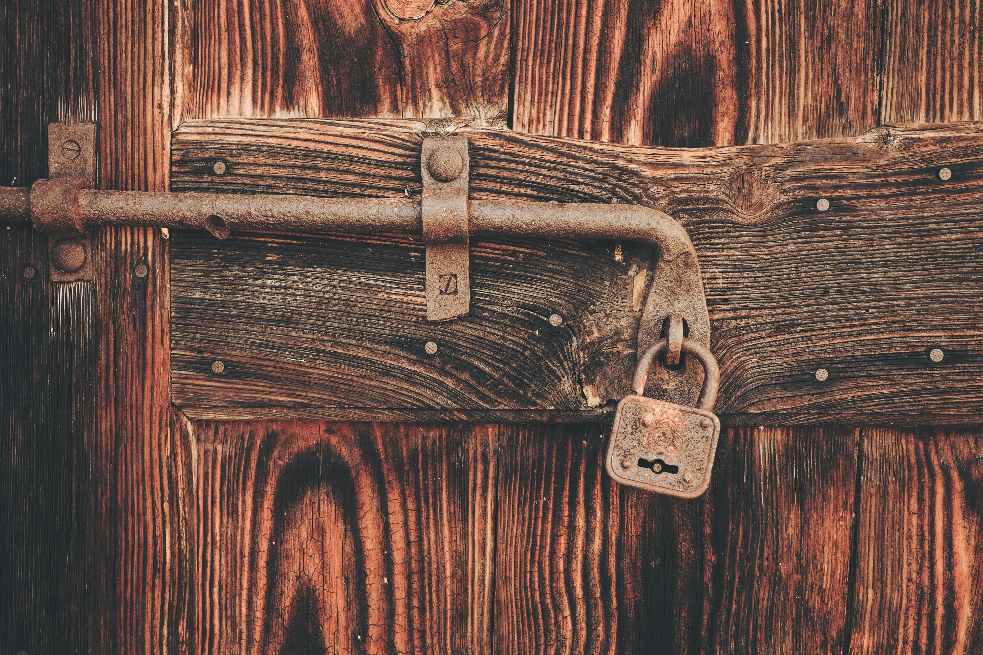 Image of a padlock on a wooden door